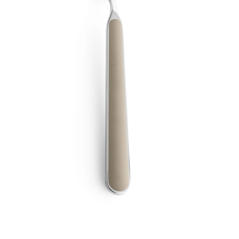 The handle of the Fantasia Salad Serving Fork from Mepra in turtle dove.