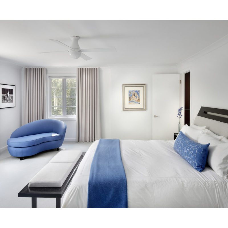 The Ball Flush ceiling fan from The Modern Fan Co. with 42" blades and the LED option. This fan has the gloss white fan finish, and white blade color in a white and blue bedroom.