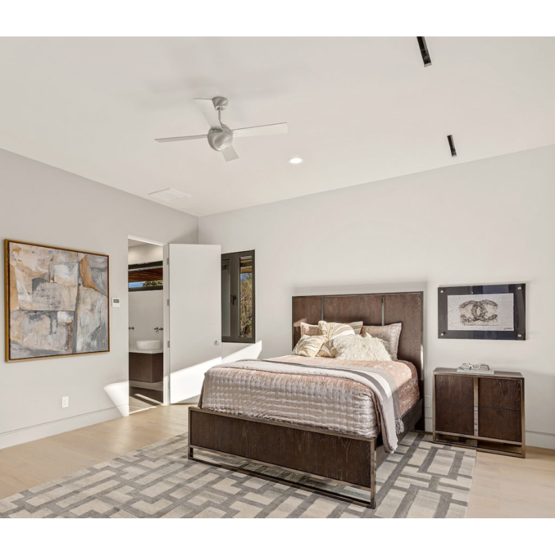 The Ball ceiling fan by Modern Fan Co. in brushed aluminum within a bedroom.