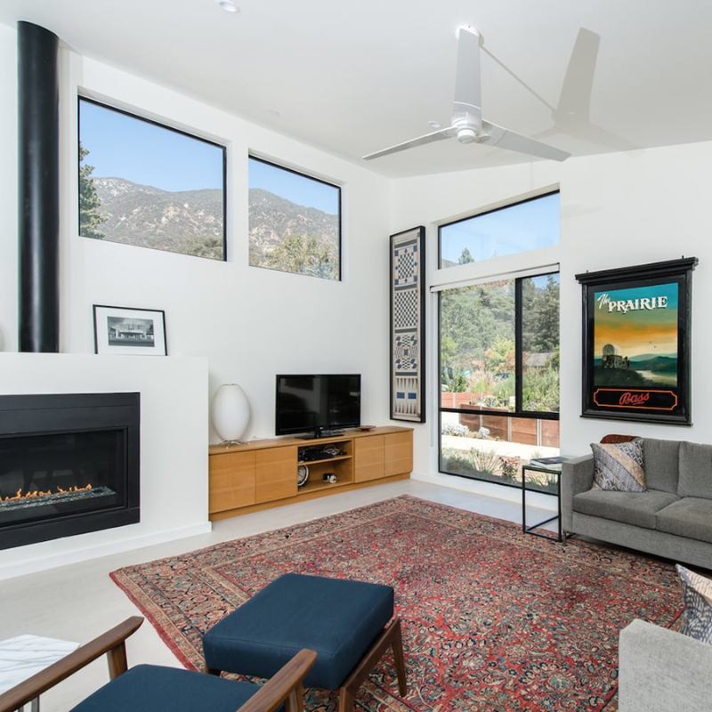 The Torsion 17W LED - 52" ceiling fan from The Modern Fan Co. within a lounge area.