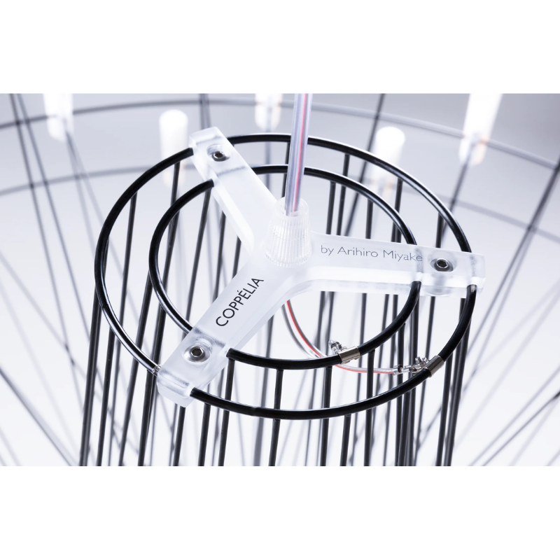 The graceful dance, staged by the three-dimensionally crossed wire structure, leads the spectator to dozens of glowing LED lights, which define the contour and the magical glow of Miyake’s interpretation of a classic chandelier.