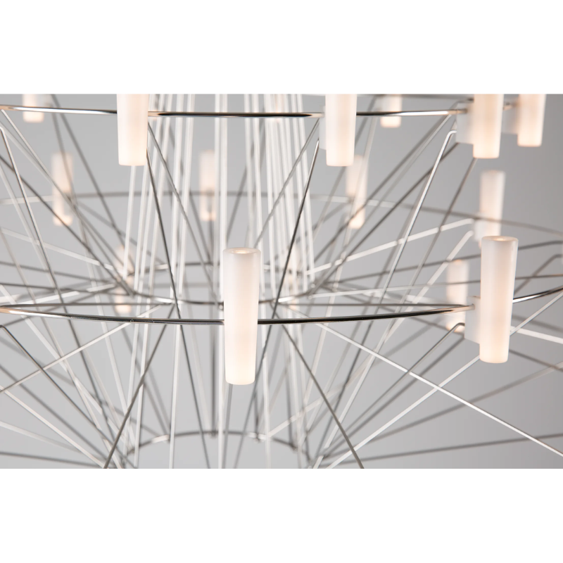 The graceful dance, staged by the three-dimensionally crossed wire structure, leads the spectator to dozens of glowing LED lights, which define the contour and the magical glow of Miyake’s interpretation of a classic chandelier.