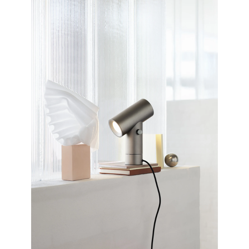 The Beam Table Lamp from Muuto on a window sill.