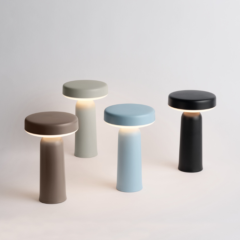 The Ease Portable Lamp from Muuto in a lifestyle image showing the four color options.