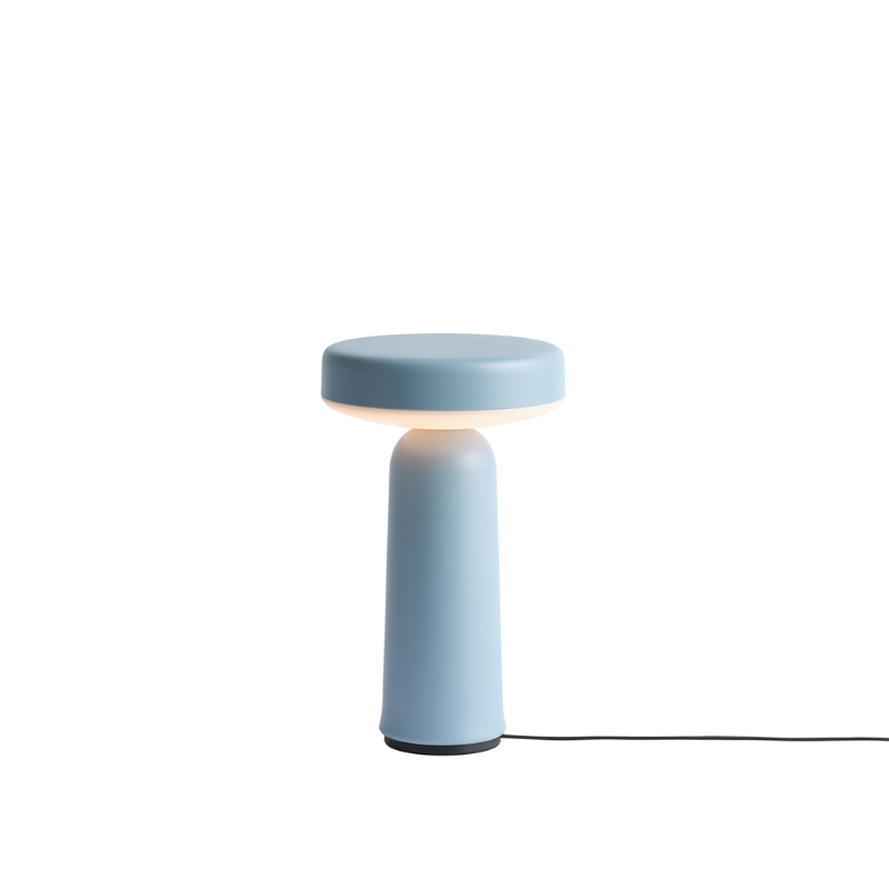 The Ease Portable Lamp from Muuto in light blue charging.