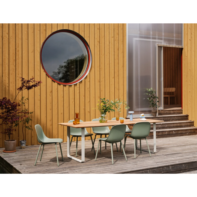 The Ease Portable Lamp from Muuto in an outdoor dining area.