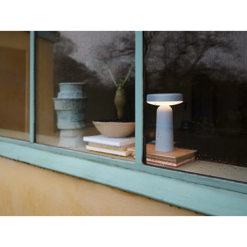 The Ease Portable Lamp from Muuto on a window sill.