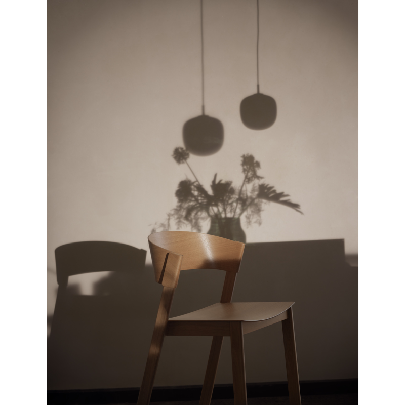 The shadow of the Rime Pendant Lamp from Muuto in a lifestyle image.