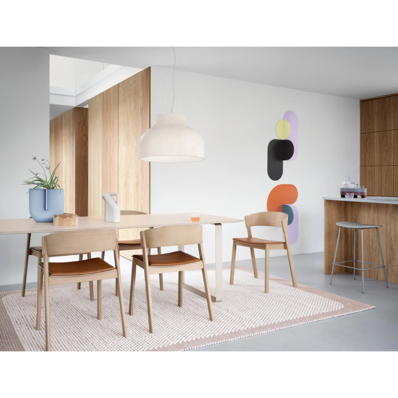 The Strand Pendant Lamp from Muuto within a living room.