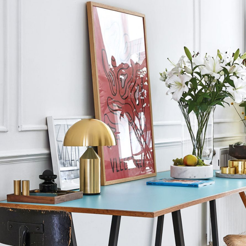This is the Atollo Gold Table Lamp from Oluce in a decorative lifestyle shot.