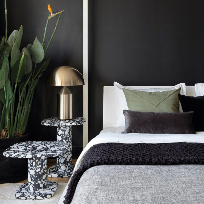 This is the Atollo Gold Table Lamp from Oluce in a bedroom.