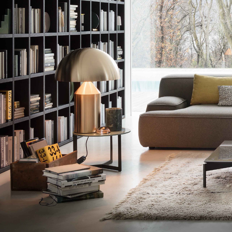 This is the Atollo Gold Table Lamp from Oluce within a home office.