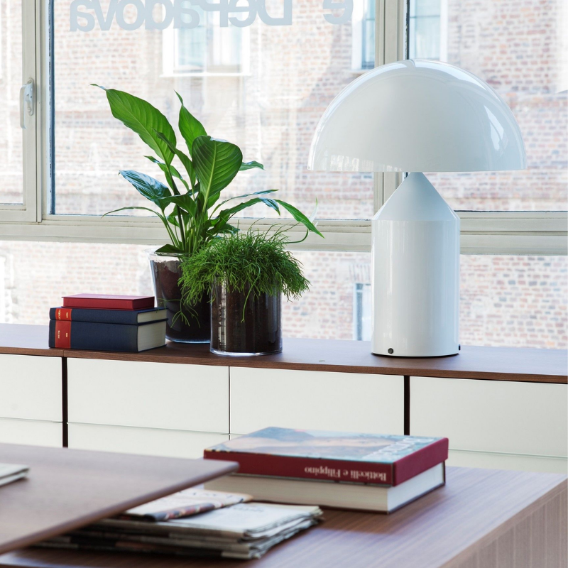 This is the Atollo Metal Table Lamp from Oluce in White within a home office.