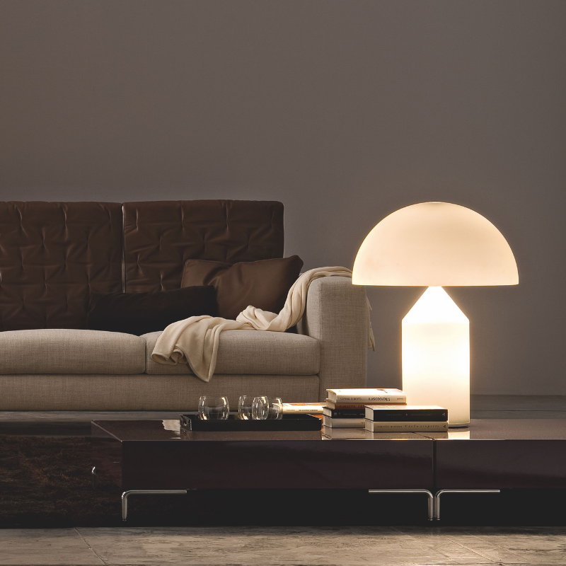 Designed in 1977 by Vico Magistretti, over the years, Atollo has become the archetype of the table lamp, winning the Compasso d Oro in 1979 and completely revolutionizing the way we imagine the classic bedside lamp. The geometric shapes that compose it, cylinder, cone and hemisphere, have resulted in a product that is decorative and essential at the same time, disconnected from the historical period and the fashions of the moment, and one that has now fully become one of the icons of Italian design.