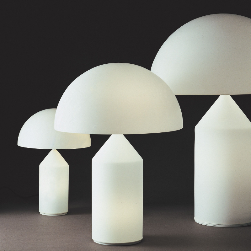 Designed in 1977 by Vico Magistretti, over the years, Atollo has become the archetype of the table lamp, winning the Compasso d Oro in 1979 and completely revolutionizing the way we imagine the classic bedside lamp. The geometric shapes that compose it, cylinder, cone and hemisphere, have resulted in a product that is decorative and essential at the same time, disconnected from the historical period and the fashions of the moment, and one that has now fully become one of the icons of Italian design.