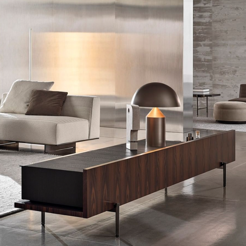 This is the Atollo Satin Bronze Table Lamp from Oluce in a living room.