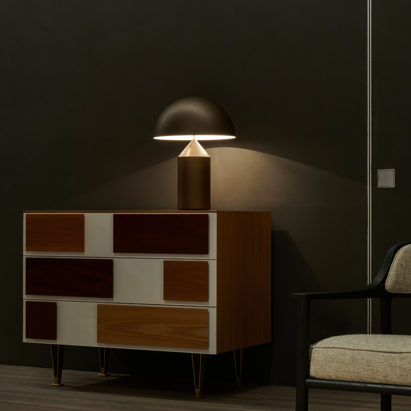 This is the Atollo Satin Bronze Table Lamp from Oluce in an office space.