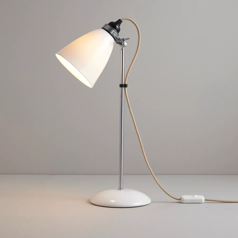 A British design classic in translucent Bone China. With its moveable shade and smart cotton braided cable, the Hector Table Light perfectly combines style and function. Available in three colors (natural white, light blue or light green) with varying sized shades.