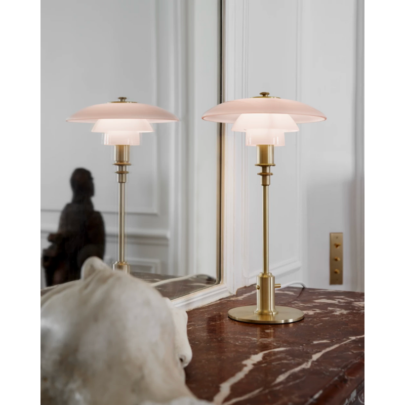 PH 2/1 Pale Rose Brass Table lamp features intricate design details, which come together to create an elegant expression and a soft, warm light in your home. The glossy pale rose shades are poetic and speak to modern interior trends, while the inside of the shades is sandblasted white, to create the glare-free light characteristic of Louis Poulsen’s lamps. 