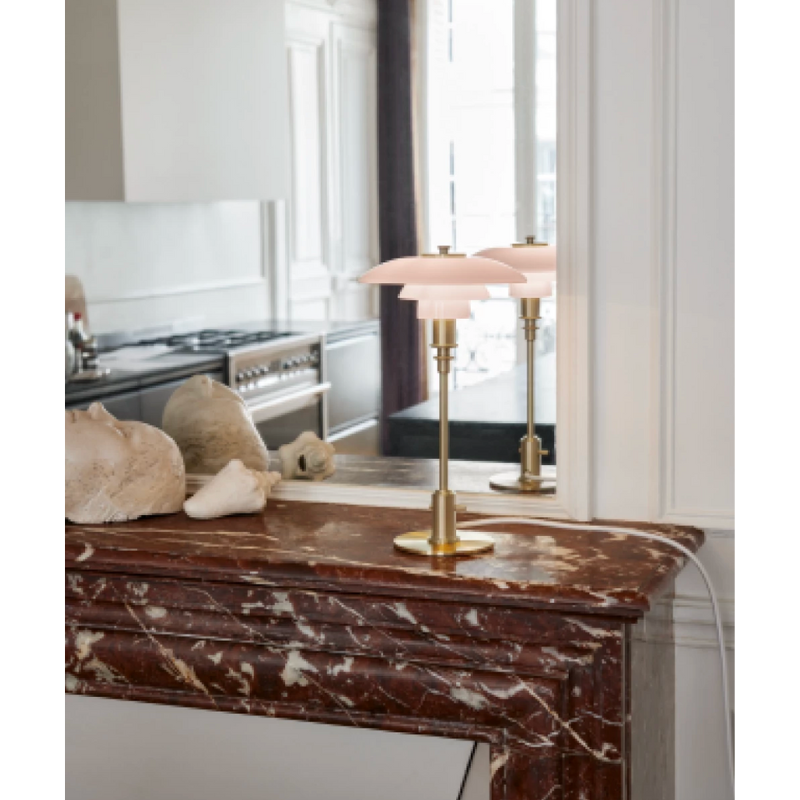 PH 2/1 Pale Rose Brass Table lamp features intricate design details, which come together to create an elegant expression and a soft, warm light in your home. The glossy pale rose shades are poetic and speak to modern interior trends, while the inside of the shades is sandblasted white, to create the glare-free light characteristic of Louis Poulsen’s lamps. 