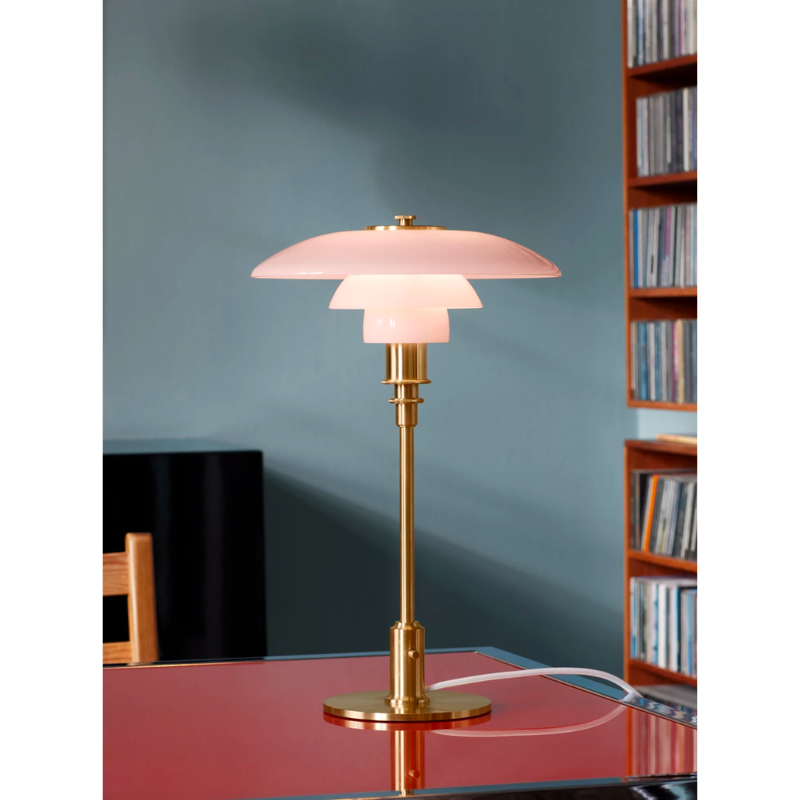 The PH 3/2 Pale Rose Table Lamp is a modern twist on this iconic design, which features pale rose-colored glass shades, paired with brushed brass elements with fine hairlines that follow the form of the fixture. 