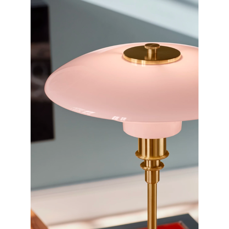 The PH 3/2 Pale Rose Table Lamp is a modern twist on this iconic design, which features pale rose-colored glass shades, paired with brushed brass elements with fine hairlines that follow the form of the fixture. 