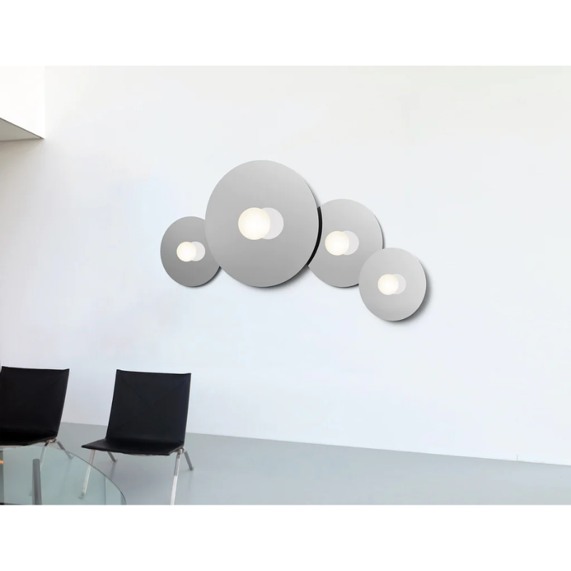 The Bola Disc Flush from Pablo Designs in a lounge area with various sizes.