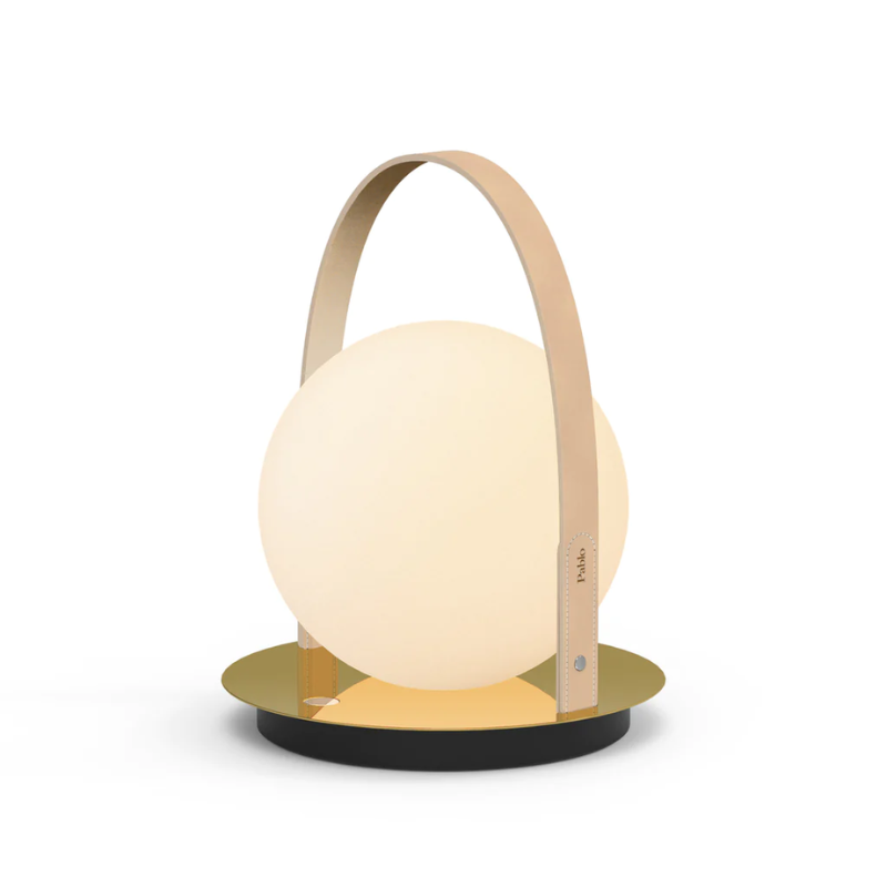 The Bola Lantern from Pablo Designs with the tan handle and brass base.