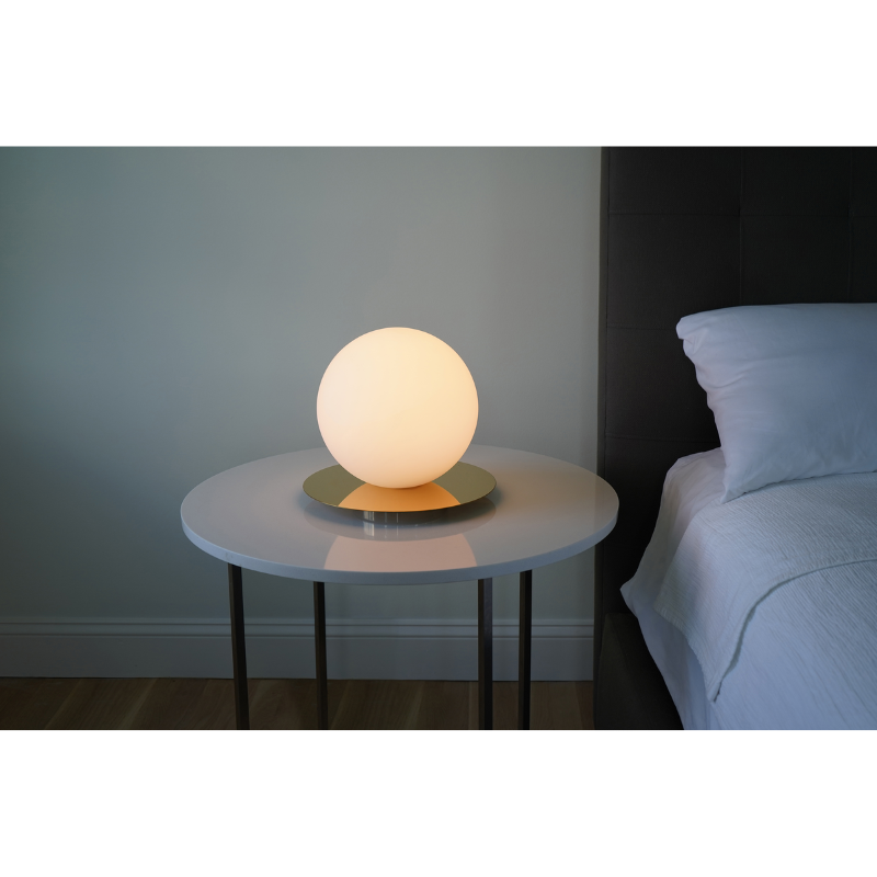 The Bola Sphere Table from Pablo Designs in a bedroom.