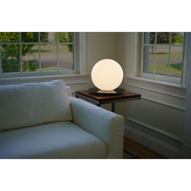 The Bola Sphere Table from Pablo Designs in a living room on a table.