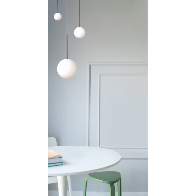 The Bola Sphere from Pablo Designs above a small family table.