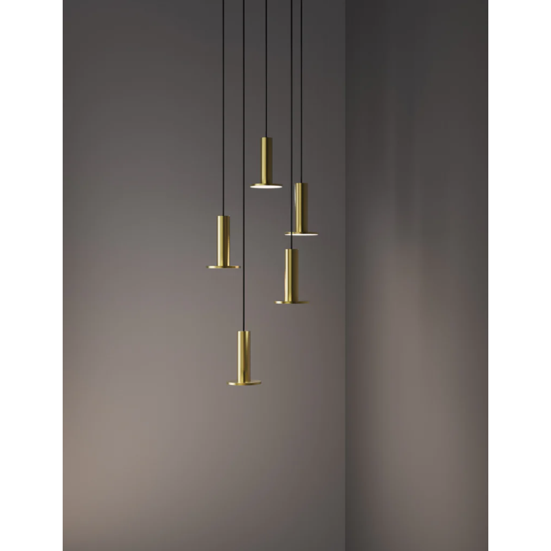 The Cielo Plus Chandelier from Pablo Designs with 5 pendants in brass, pictured naturally suspended from a ceiling in a lifestyle shot.