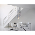 The Cielo Plus Chandelier from Pablo Designs hovering over a dining room table.