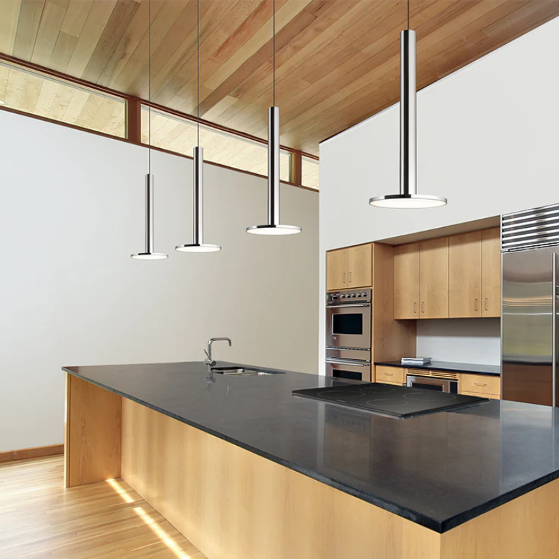 The Cielo XL from Pablo Designs in a lifestyle shot of them suspended over a kitchen counter, stove and sink.
