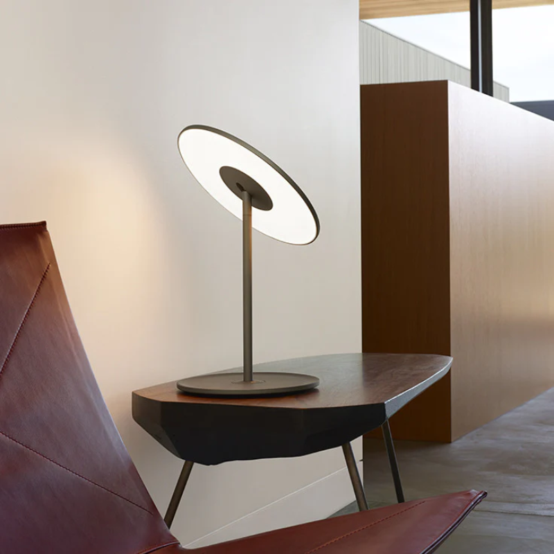 The Circa Table light from Pablo Designs in a living room on a side table.