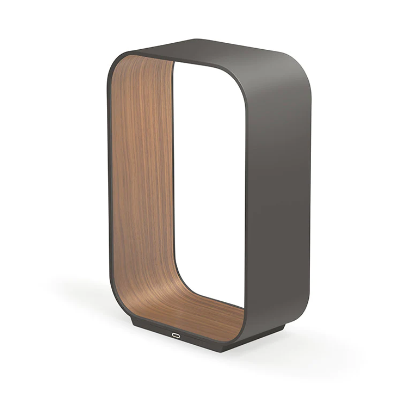The small version of the Contour Table light from Pablo Designs in graphite and walnut.