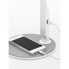 The LIM360 Table from Pablo Designs being shown with a phone being charged by the USB port.