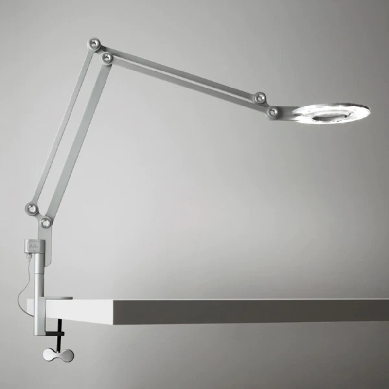 The medium Link Clamp from Pablo Designs in silver mounted to a table. all-groups