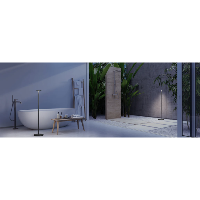 The Luci Floor by Pablo Designs in an indoor and outdoor bathroom showing the versatility of this portable LED light.