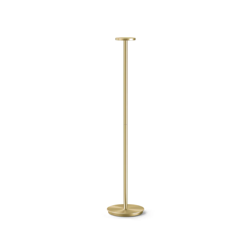 The portable light, Luci Floor from Pablo Designs in brass.