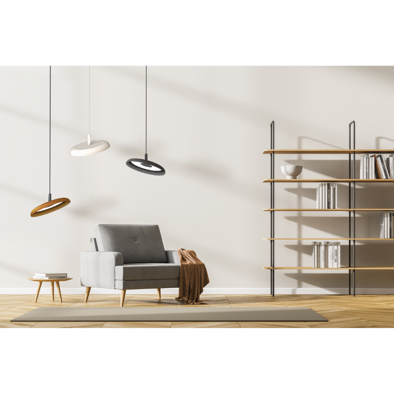 Three of the Nivél Pendants from Pablo Designs in a living room in various shade colors and cord colors.