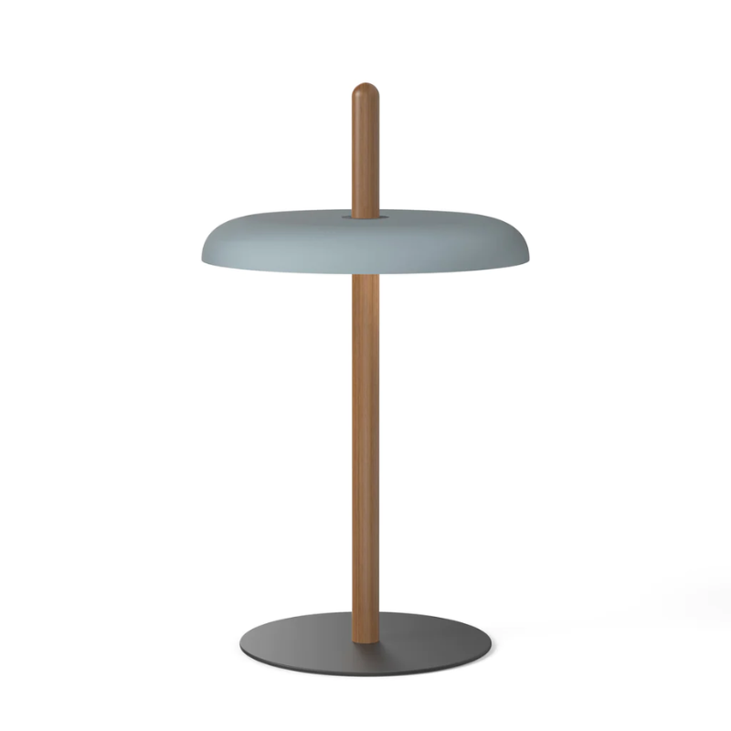 The Nivél Table from Pablo Designs with an walnut post and slate blue shade.