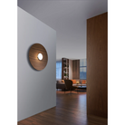 The Sky Dome Flush Wood from Pablo Designs mounted to the wall in a living room.