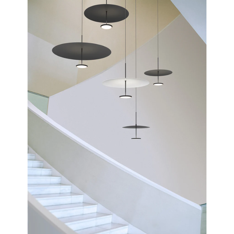 A display of multiple color and sizes of the Sky Dome Metal by Pablo Designs. Depicted is the Matte Black and Black, Matte Black and White versions in 3 varying sizes over a staircase in a hallway.