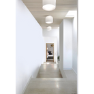 The Totem Up/Down Light from Pablo Designs in a hallway leading to a bedroom.