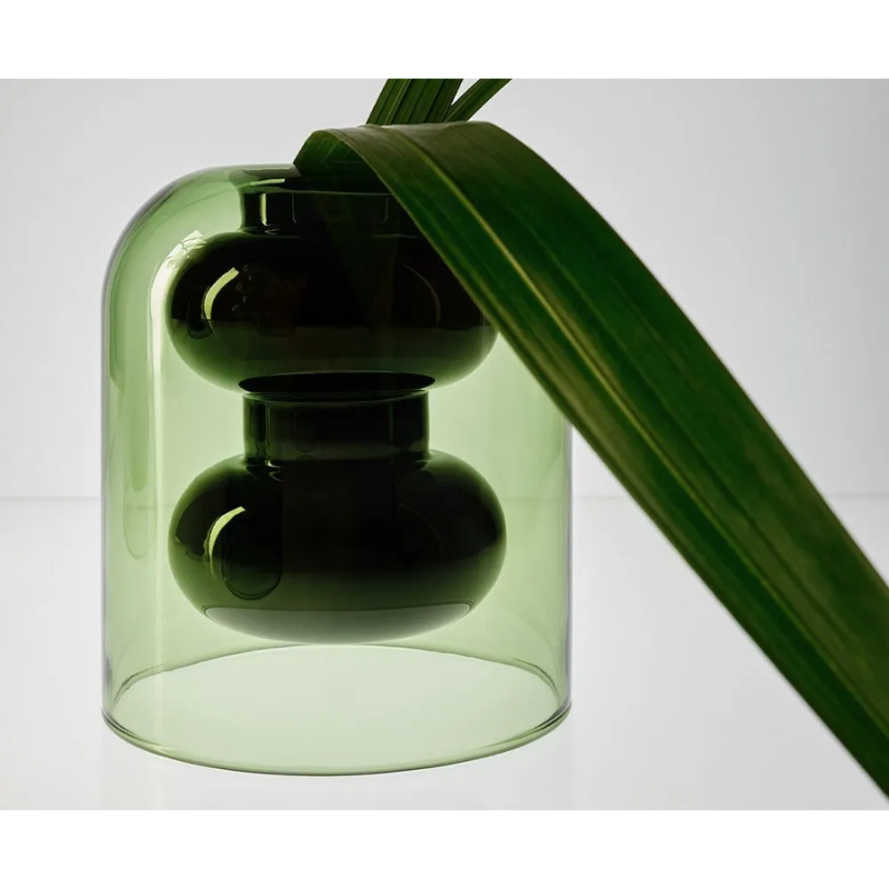 The Bump Vase Short Black by Tom Dixon being used for a plant.
