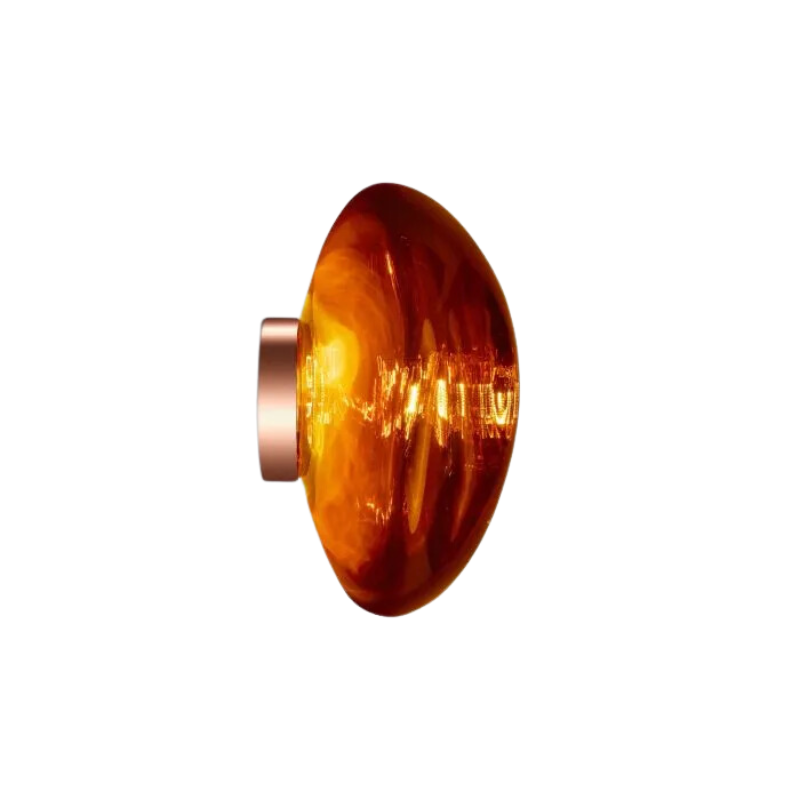 Tom Dixon's Melt LED Surface Wall Sconce is a beautifully distorted pendant in collection of modern finishes with matching ceiling rose. Featuring an integrated LED module, this ceiling light creates a mesmerizing melting hot-blown glass effect when turned on, and a mirror-finish effect when off. This piece is made in Germany using a high tech manufacturing techniques to achieve the perfect melted orb for your design.