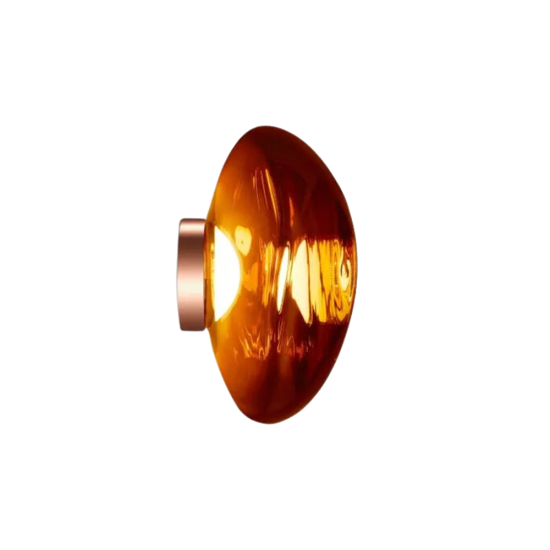 Tom Dixon's Melt LED Surface Wall Sconce is a beautifully distorted pendant in collection of modern finishes with matching ceiling rose. Featuring an integrated LED module, this ceiling light creates a mesmerizing melting hot-blown glass effect when turned on, and a mirror-finish effect when off. This piece is made in Germany using a high tech manufacturing techniques to achieve the perfect melted orb for your design.