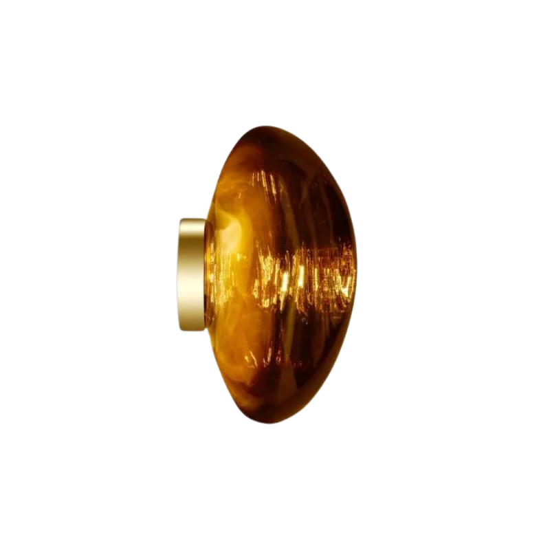 Tom Dixon's Melt LED Surface Wall Sconce is a beautifully distorted pendant in collection of modern finishes with matching ceiling rose. Featuring an integrated LED module, this ceiling light creates a mesmerizing melting hot-blown glass effect when turned on, and a mirror-finish effect when off. This piece is made in Germany using a high tech manufacturing techniques to achieve the perfect melted orb for your design.