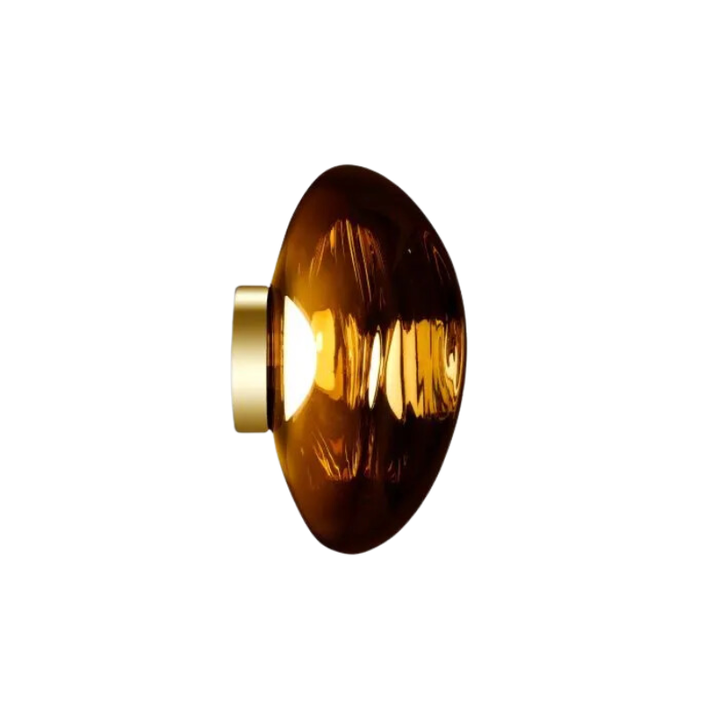 Tom Dixon's Melt LED Surface Wall Sconce is a beautifully distorted pendant in collection of modern finishes with matching ceiling rose. Featuring an integrated LED module, this ceiling light creates a mesmerizing melting hot-blown glass effect when turned on, and a mirror-finish effect when off. This piece is made in Germany using a high tech manufacturing techniques to achieve the perfect melted orb for your design.